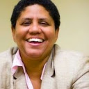 Yvonne Z. Smith, African-American woman smiling with light tan coat. She chairs the Mental Health Subcommittee for National Council on Independent Living.