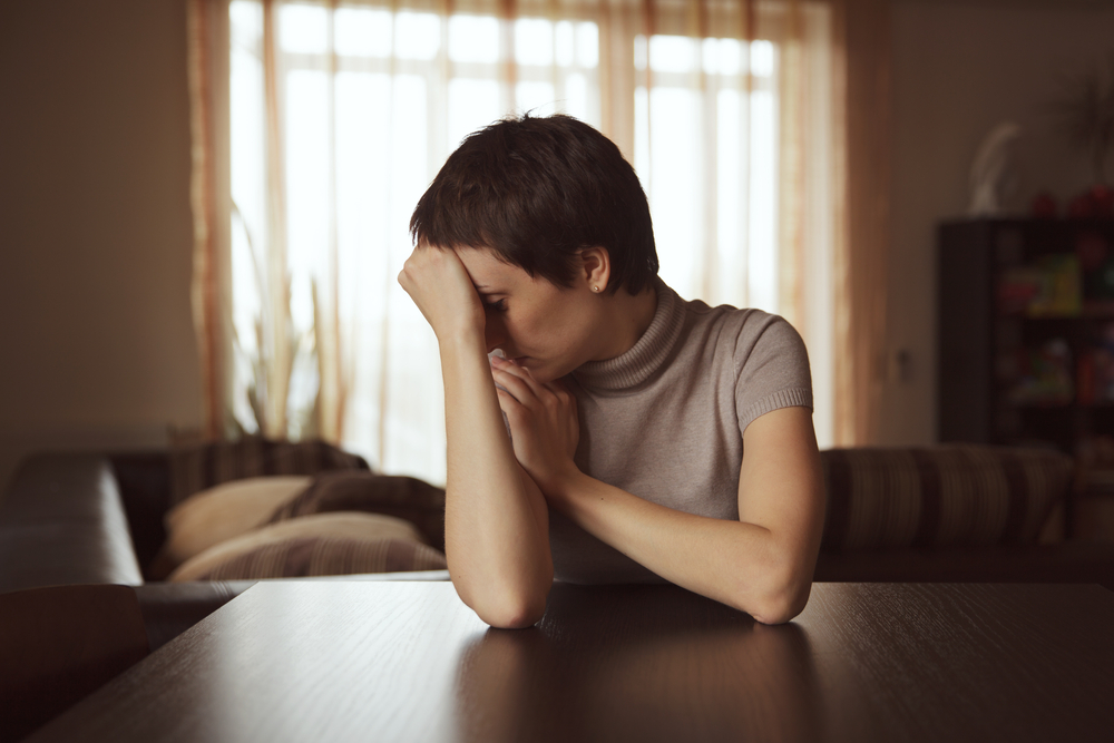 Sad looking woman sitting at the table