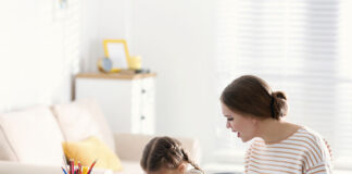 A Therapist Tried to Explain CBT When I Was 11 Years Old, Ineffectively Stock photo of unhappy little girl; adult woman is trying to make her do worksheets