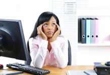 Psychological Science Is Rooted in Racism Stock photo of an unhappy young black business woman at desk in office