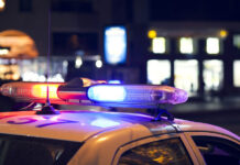 Police Say They Are Willing to Help the “Mentally Ill”—But Still Seek to Avoid Them and View Them as “Dangerous” Blue light flasher atop of a police car. City lights on the background.