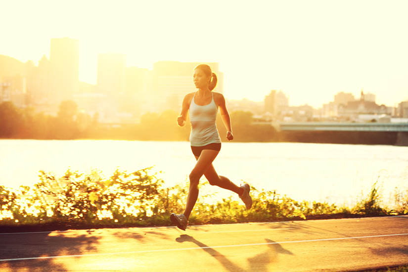 Photo of a female runner at sunset