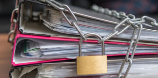 “Beware, Scientology Related”: How ADHD Experts Silence Criticism Photo of a padlock chaining a set of document binders