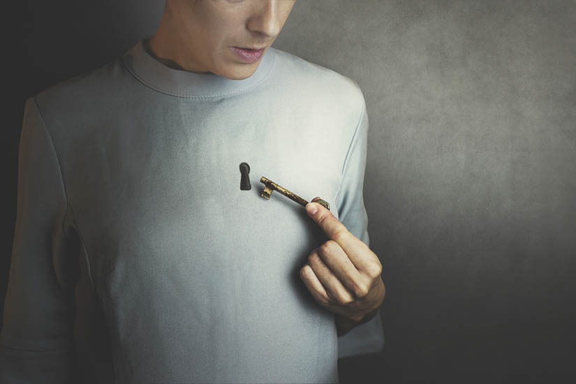 Illustration depicting a keyhole in a person's shirt/chest. They are holding an old-fashioned skeleton key near it.