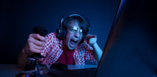 What Video Games Can Teach Us About Effective Parenting teen boy playing video game intensely