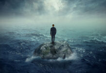 Thomas Szasz Versus the Mental Health Movement Illustration of a man standing on a rock surrounded by ocean waves