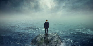 Thomas Szasz Versus the Mental Health Movement Illustration of a man standing on a rock surrounded by ocean waves