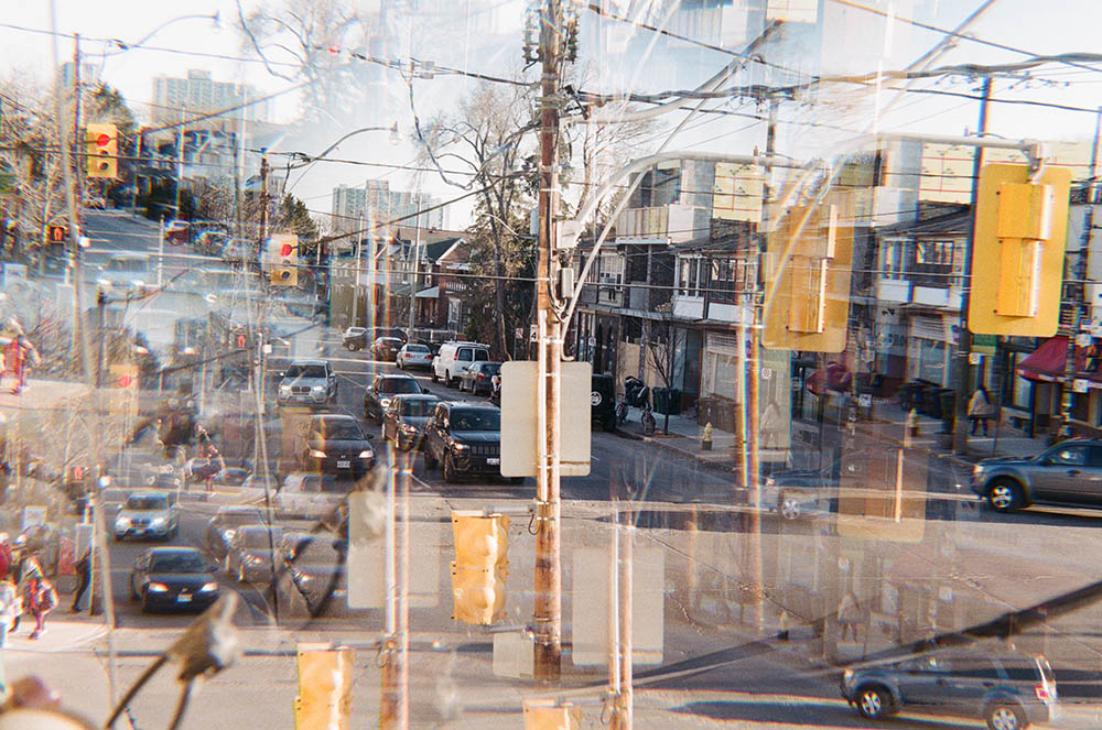 A kaleidoscopic photograph depicting a busy street, reflected multiple times