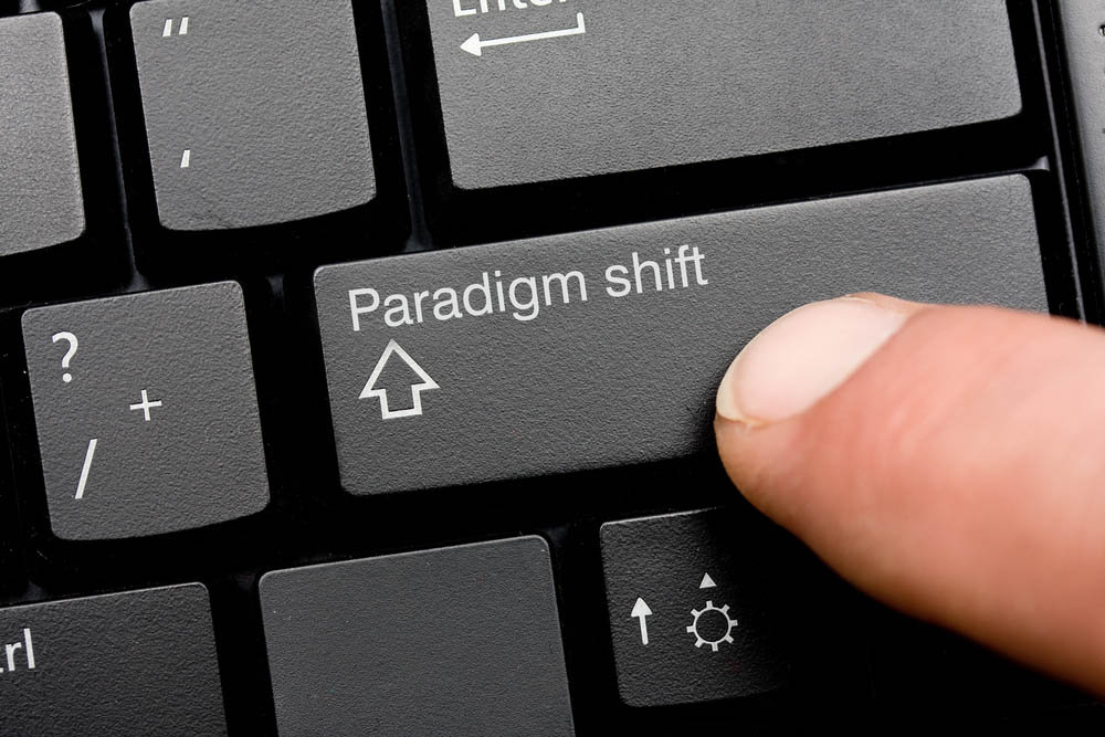 Close-up photo of the shift button on a computer keyboard, but it's labeled "Paradigm shift."