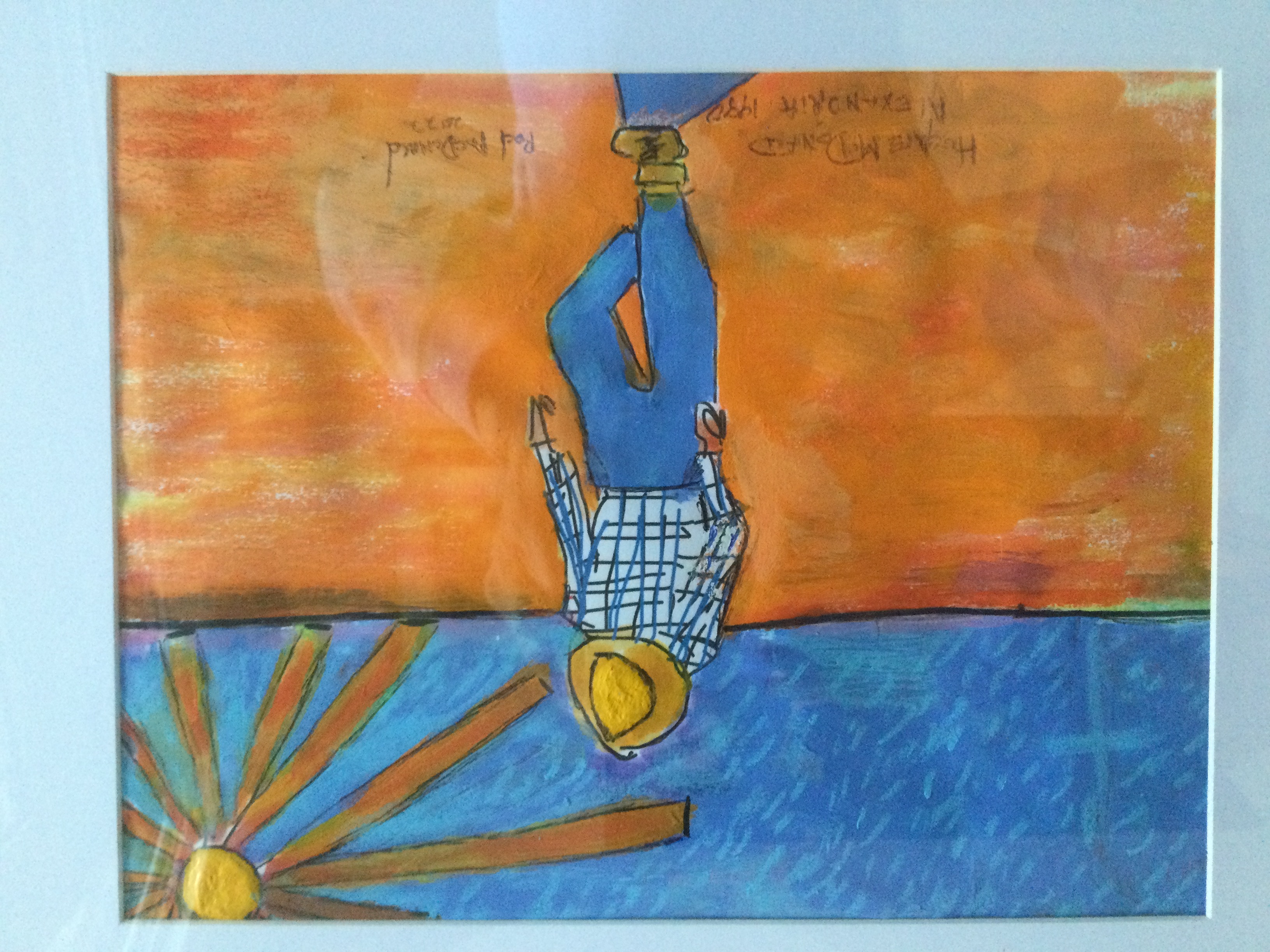 Man looking down with hat, sun in background, blue plaid shirt