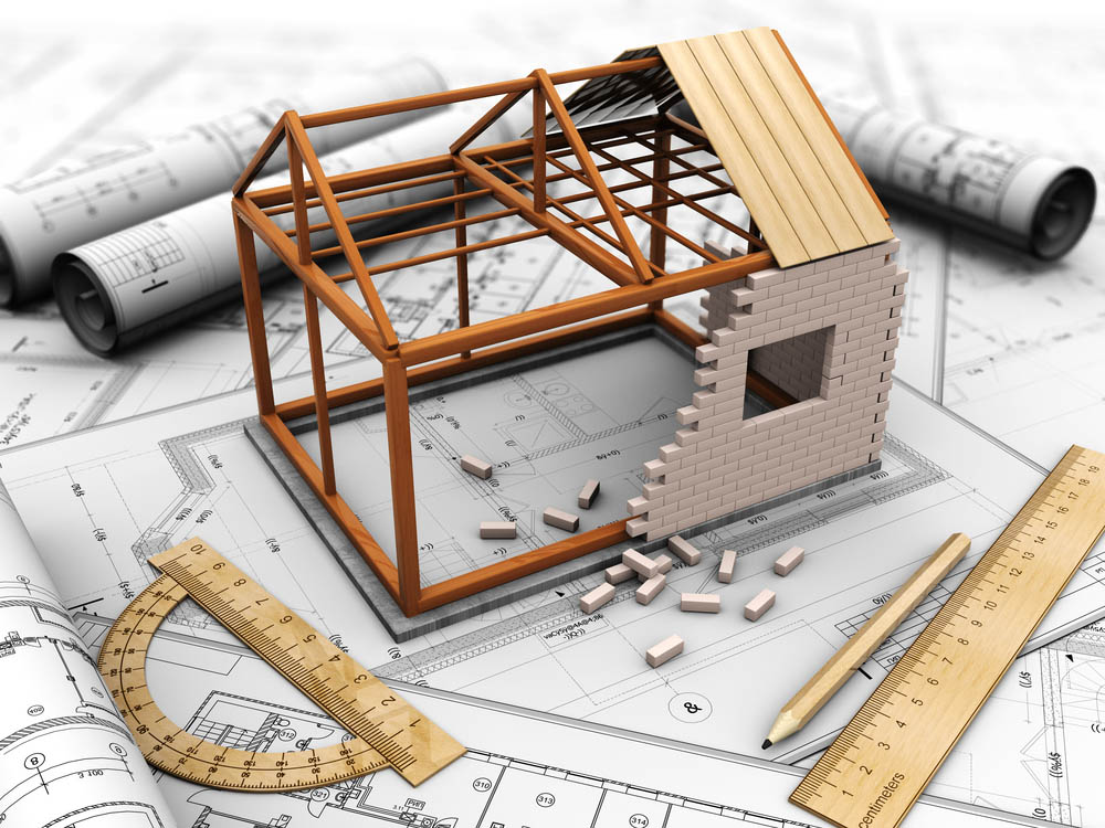 3D illustration of a model house in construction on a table of blueprints