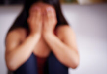 Sexual Violence in Adolescence Associated with Increased Risk of Suicide, Self-harm, and Psychological Distress Close up of a blurred young woman covering her face