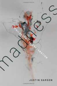 Cover art for "Madness"; an abstract design in red and black that resembles a human-like figure