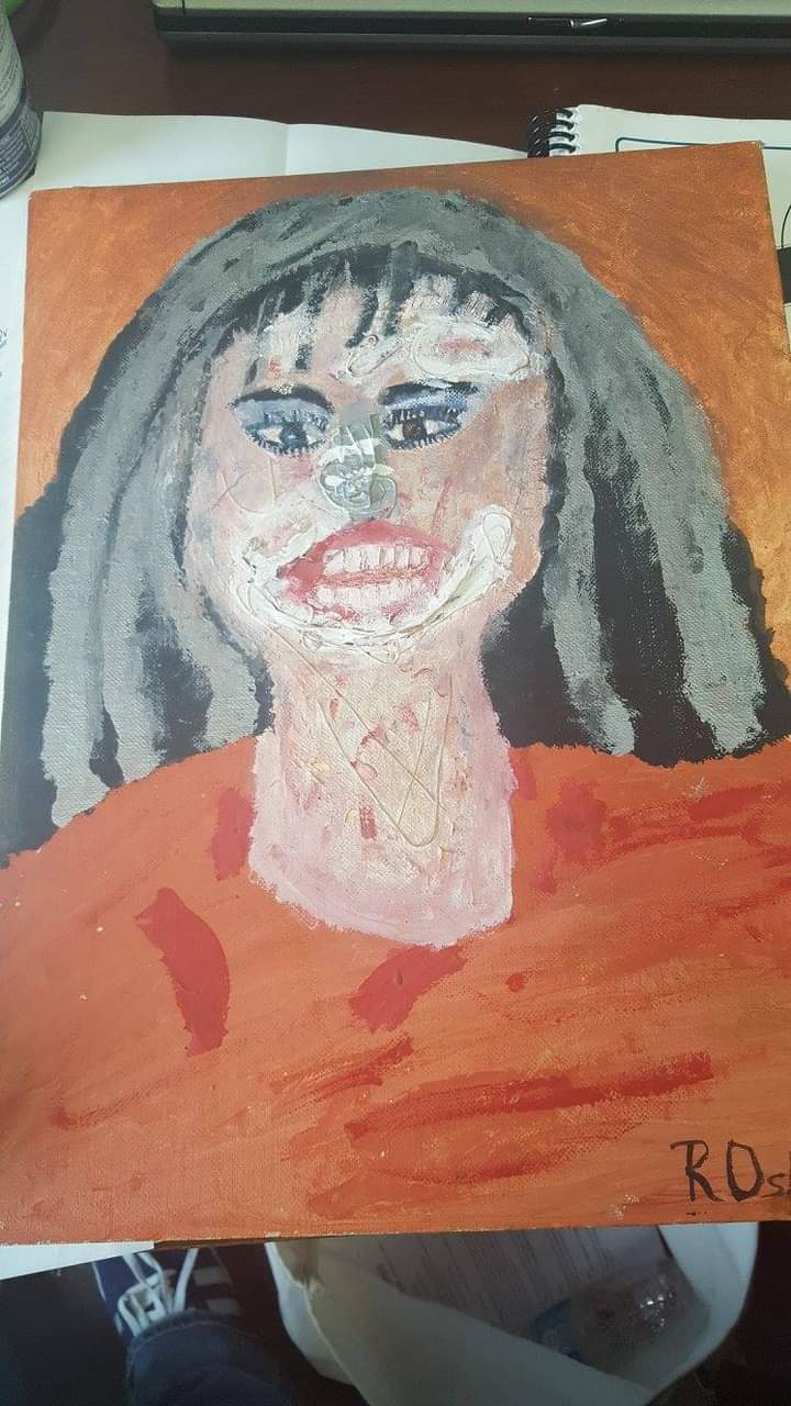 Women with battered face and orange shirt