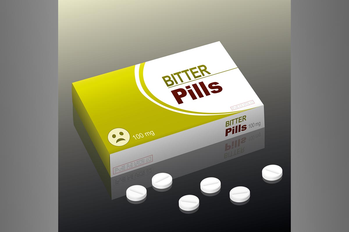 Illustration of a box labeled "BITTER Pills" with some small capsules beside it