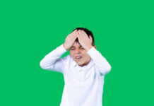 The Faulty Reasoning That Turned ADHD Into a Disease A boy is holding a head. He is unhappy and upset.