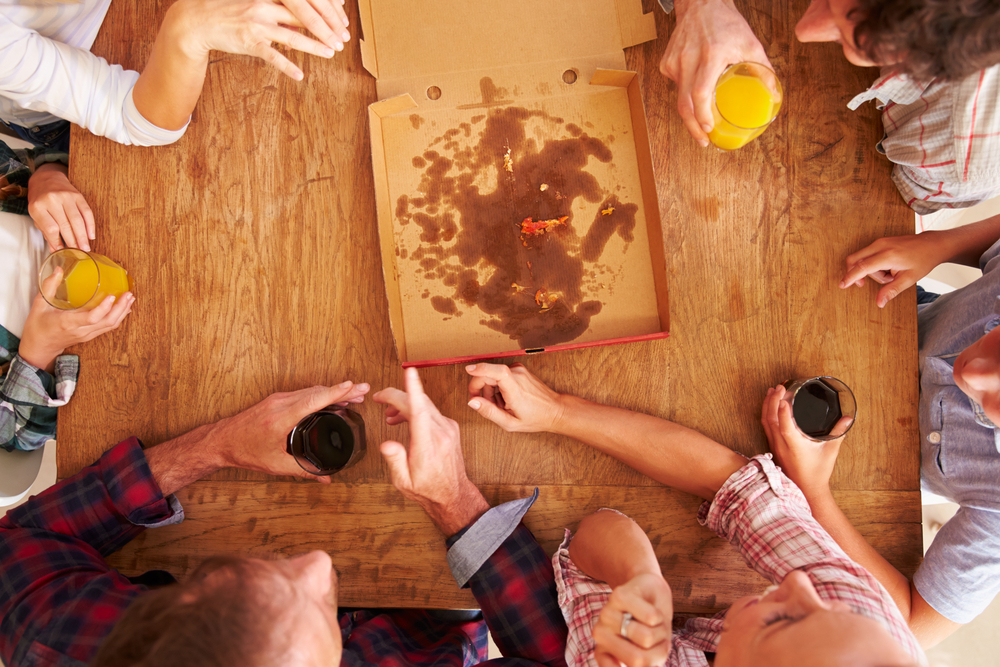 Friends sharing a pizza together, overhead view