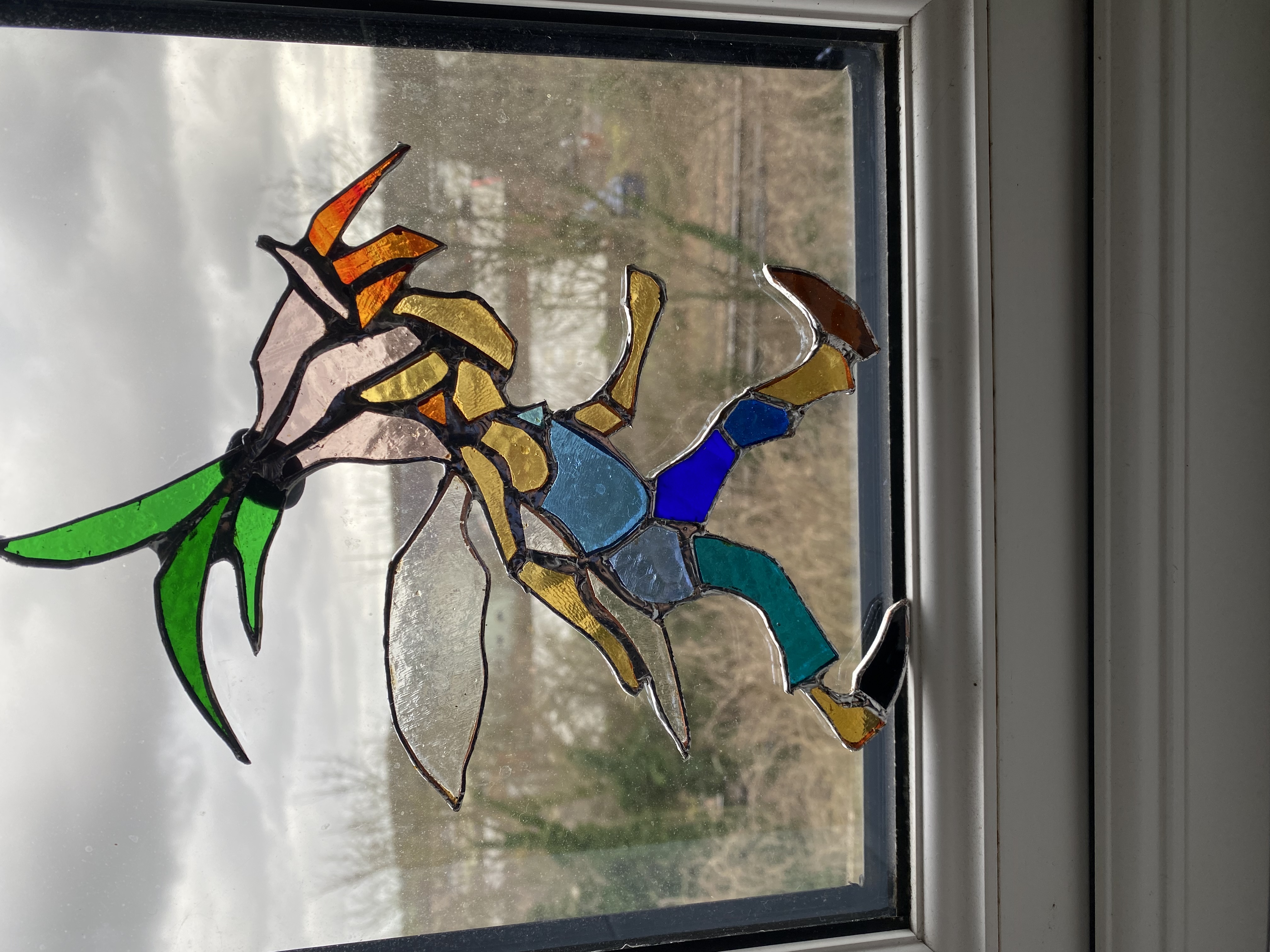 stained glassed of person walking with flower on head