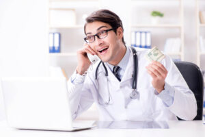 Stock photo of a doctor holding money and talking on the phone