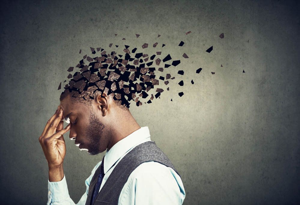 A Black man in a suit, in profile, with his head being fragmented digitally