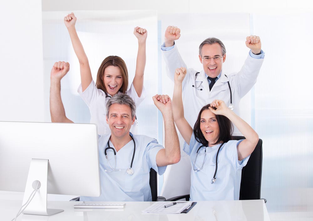 Group Of Happy Excited Doctors Raising Arms