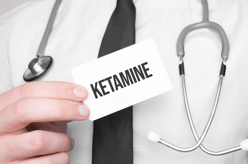 Doctor holding a card with text ketamine