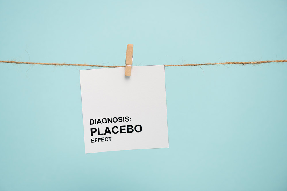 Illustration depicting a card on a clothesline reading "DIAGNOSIS: PLACEBO EFFECT" against a blue background