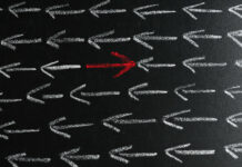 The APA’s Apology for Racism Omits Psychiatry’s Essential Bigotry Chalkboard with white arrows and one red pointing in different direction