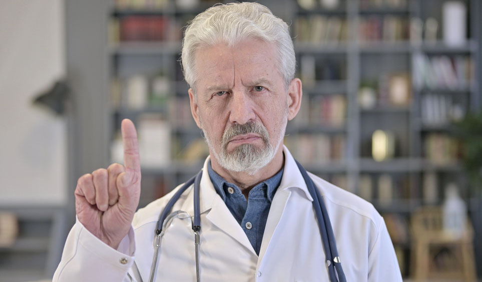 Photo of older white doctor with beard shaking his finger 