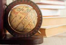 Rethinking Culture and Colonialism in the History of Global Mental Health Globe and old books on the desk.