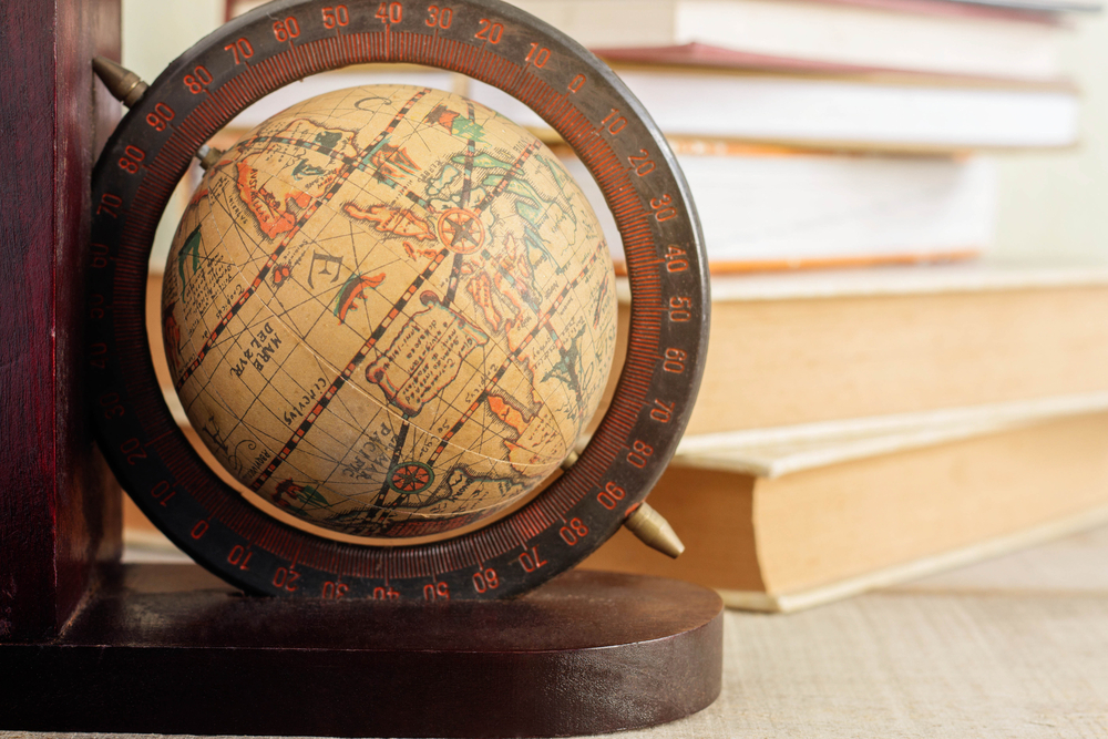 Globe and old books on the desk.