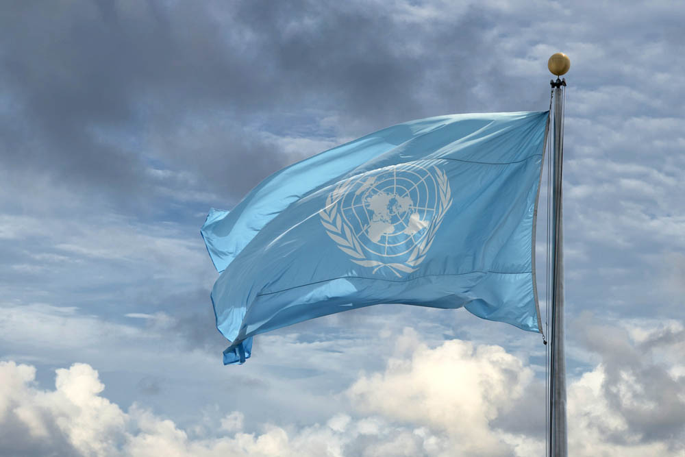 UN flag against cloudy background