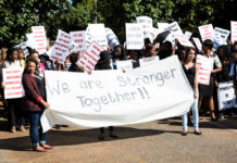 Challenging the Biomedical Imperative in Global Mental Health with Clinical-Community Psychology Johannesburg, South Africa - April 30, 2015: Woman's protest march in suburban street