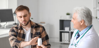 Antipsychotics Lead to Worse Outcomes in First-Episode Psychosis Young man refusing to take prescribed pills in clinic