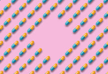 SSRI Withdrawal has Social, Cognitive, and Emotional Consequences Pattern of blue and yellow pills or tablets on a pink background. concept of medicine, pharmacy and coronavirus. copy space