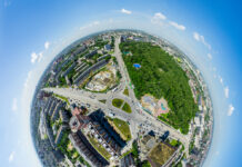 Living Near Greenspace Linked to Fewer Antidepressant Prescriptions Aerial city view with crossroads and roads, houses, buildings, parks and parking lots, bridges. Urban landscape. Copter shot. Panoramic image.