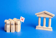 Maryland Enacts a âDraconianâ Assisted Outpatient Treatment Program Stock photo of wooden people and government building; people protesting