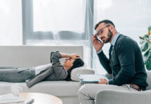 How to Know if You Have an Abusive Therapist Stock photo of male therapist looking annoyed. Female client on couch