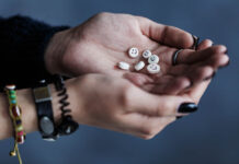 Do Depression Pills Improve Quality of Life? Photo of cupped hands holding little pills with smiley faces on them