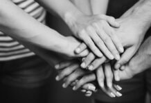 Greater Role for Experts by Experience in the Dialogue on Euthanasia in Cases of Psychological Suffering Is Desired Black and white photo of many hands laid on top of each other