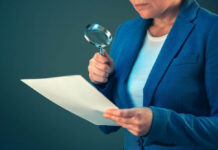 Seriously Misleading Testimony by Psychiatry Professor in Oslo District Court About the Effect of Antipsychotics Professional woman looking at documents with magnifying glass