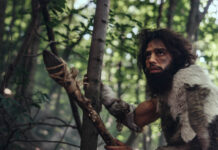 Beyond the Chemical Imbalance: Looking to the Past to Understand the Mental Health Crisis Portrait of Primeval Caveman Wearing Animal Skin and Fur Hunting with a Stone Tipped Spear in the Prehistoric Forest. Prehistoric Neanderthal Hunter Ready to Throw Spear in the Jungle