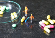 Irrational Polypharmacy: How Integrated Mental Health Treatment Can Help Miniature people - The worker at work with medicine pills