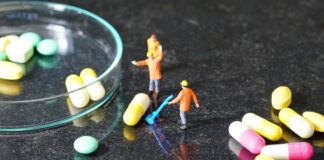 Irrational Polypharmacy: How Integrated Mental Health Treatment Can Help Miniature people - The worker at work with medicine pills