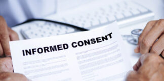 Who Can Consent to Research—and What Does That Mean for Forced Treatment? Close up of document titled "Informed Consent" being held