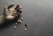 Suicides Increase After National Suicide Prevention Introduced Pills spilling out of an outstretched hand