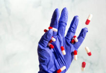 The Ethics of Long-Term Psychiatric Drug Use and Why We Need a Better Way Pills falling out of a doctor's gloved hand