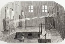 An engraving depicting water being shot at two prisoners; hydrotherapy