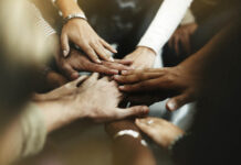 Photo of diverse hands in center of huddle