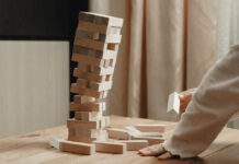 A jenga tower of bricks begins to collapse